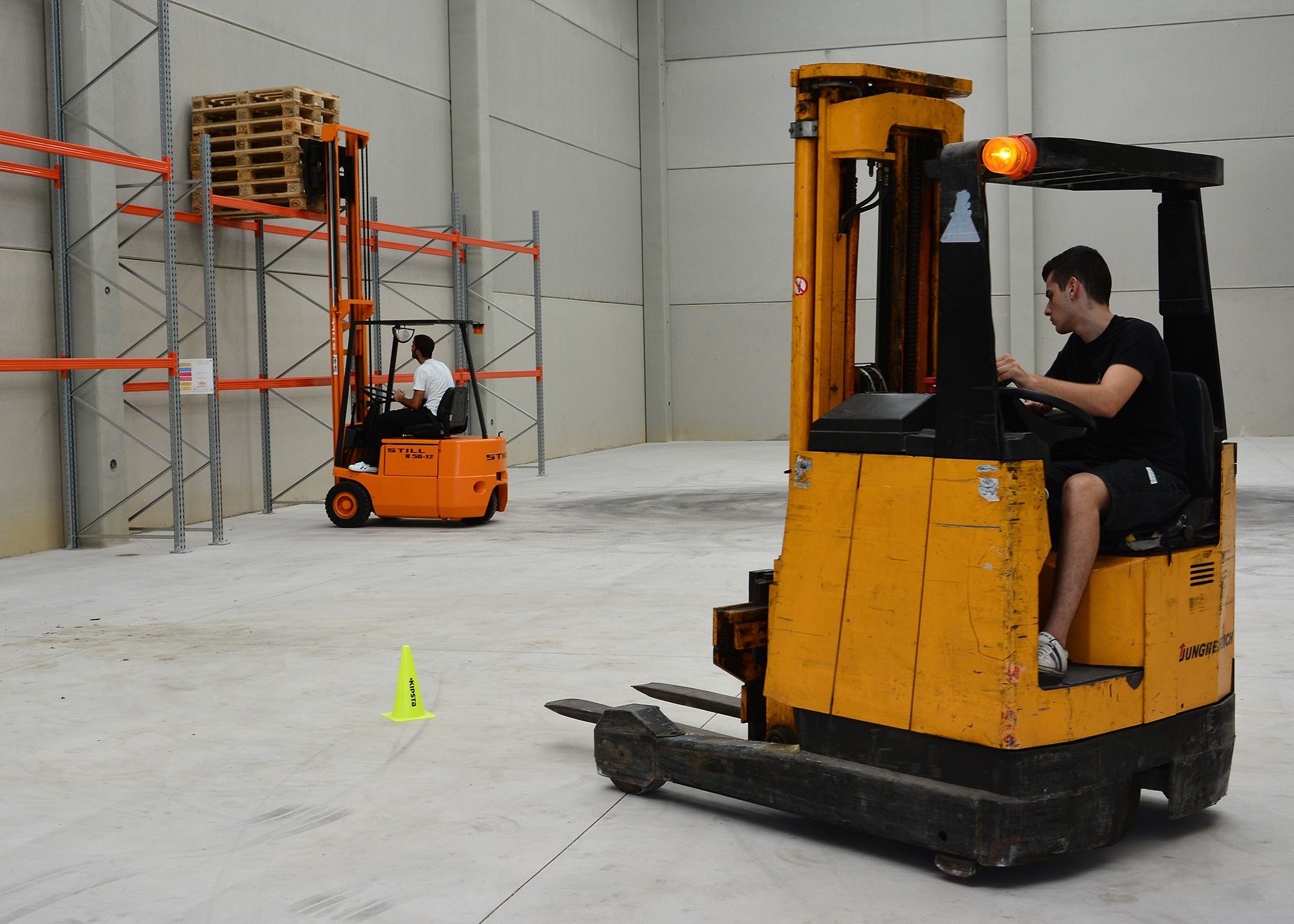 Two man working on pallet trucks